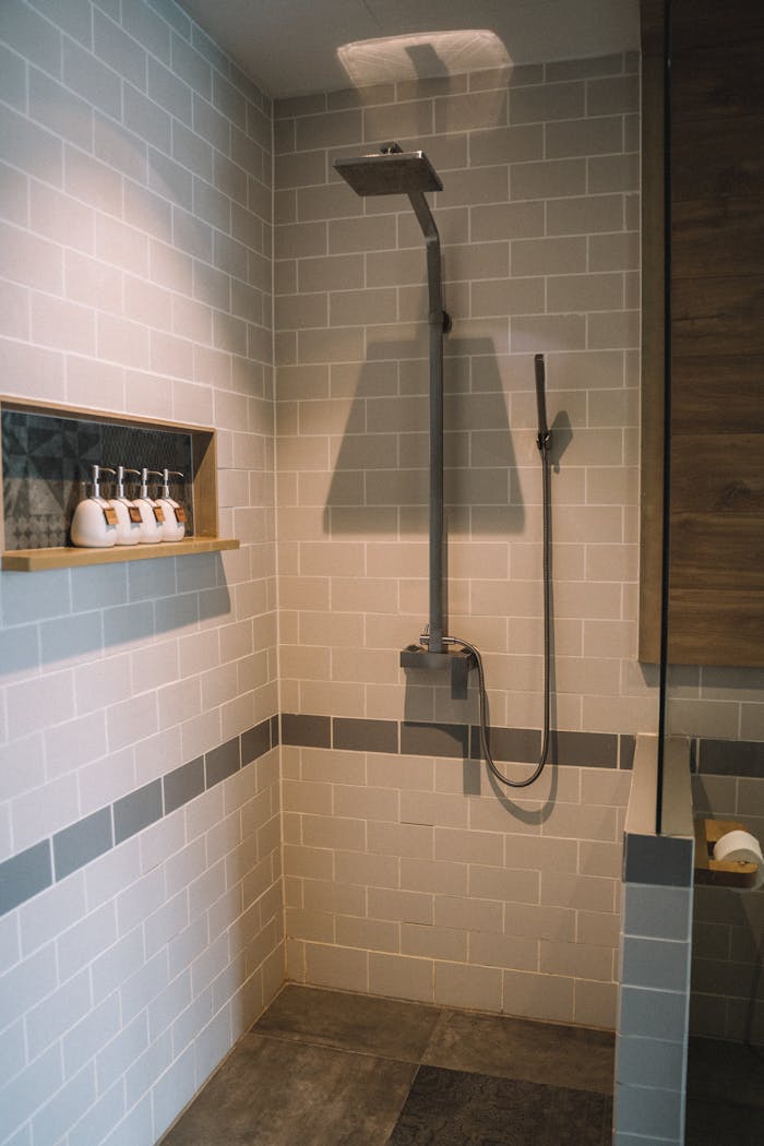 services-01 Elegant bathroom interior with a sleek shower and tile design.